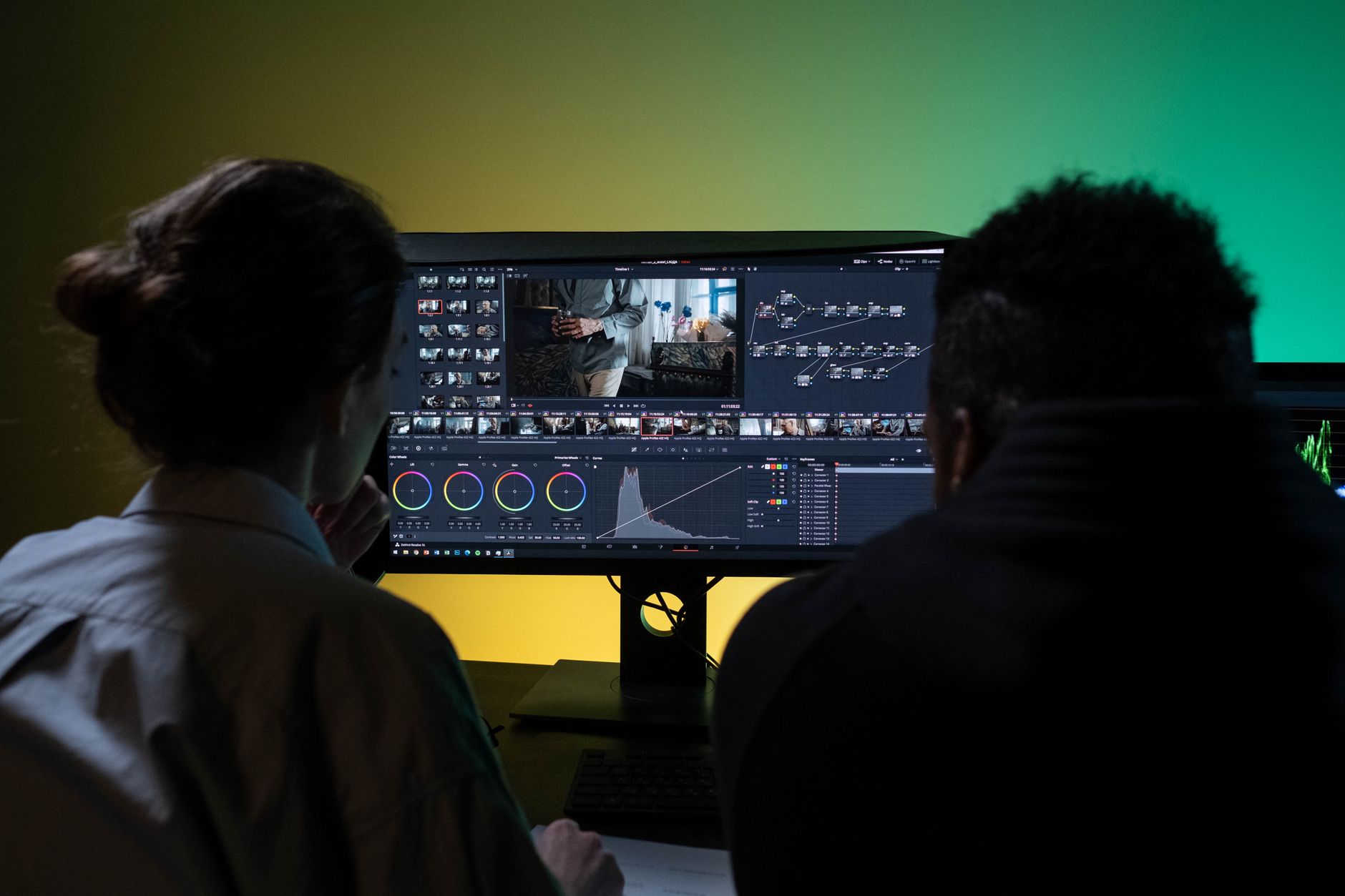 A director and visual effects team collaborating at monitor screens