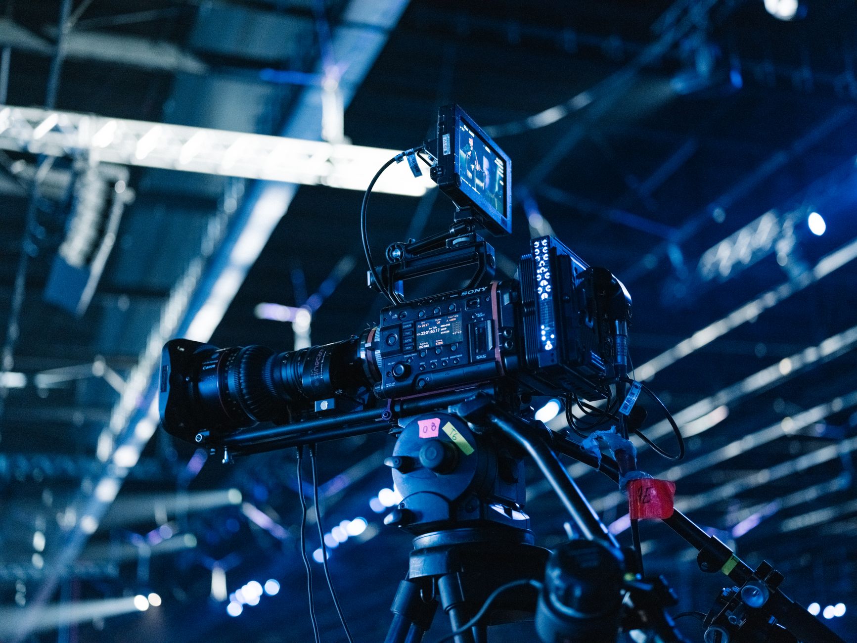 Cinematographer operating video camera on dark moody film set